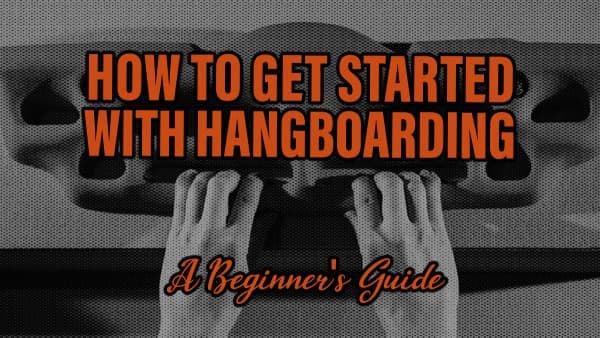 Black-and-white view of two hands gripping the edges of a hangboard training board