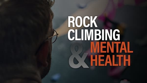 Bearded man in glasses seen from behind, looking toward a climbing wall, beneath text about rock climbing and mental health