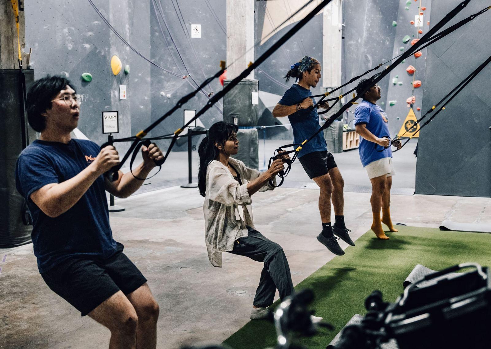 Members in a TRX class on the fitness turf