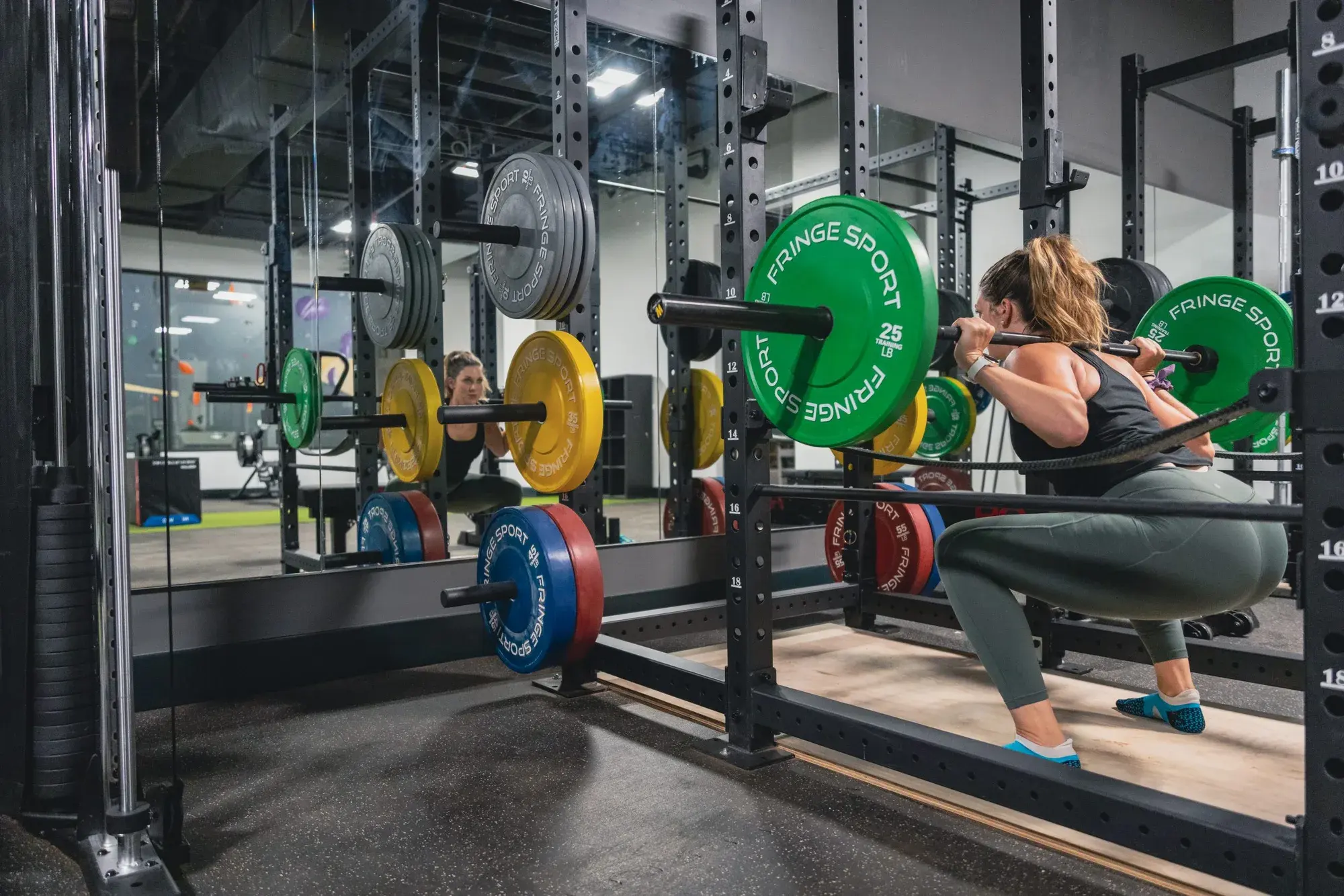Member squatting in the Method weightlifting area