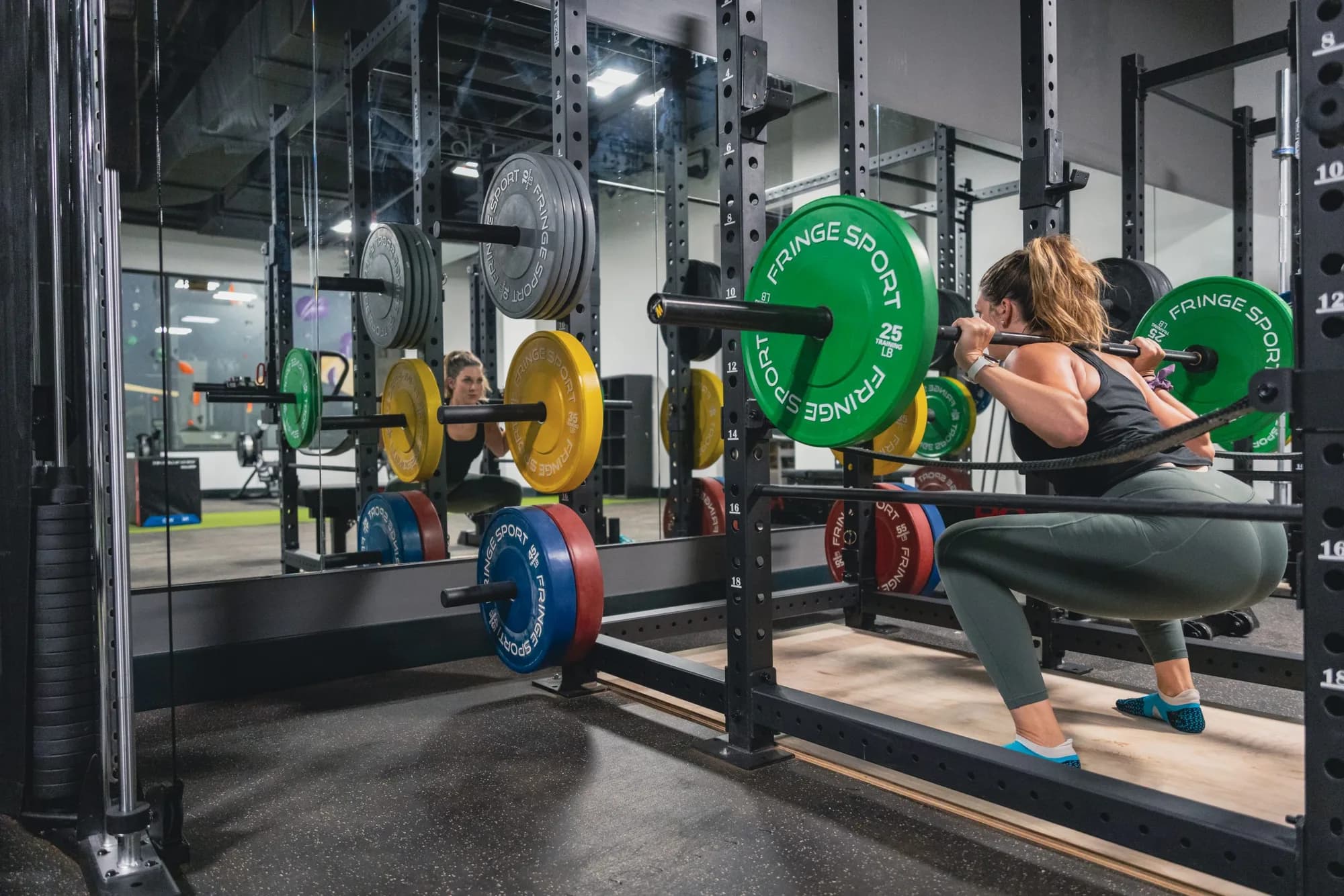 Member squatting in the Method weightlifting area