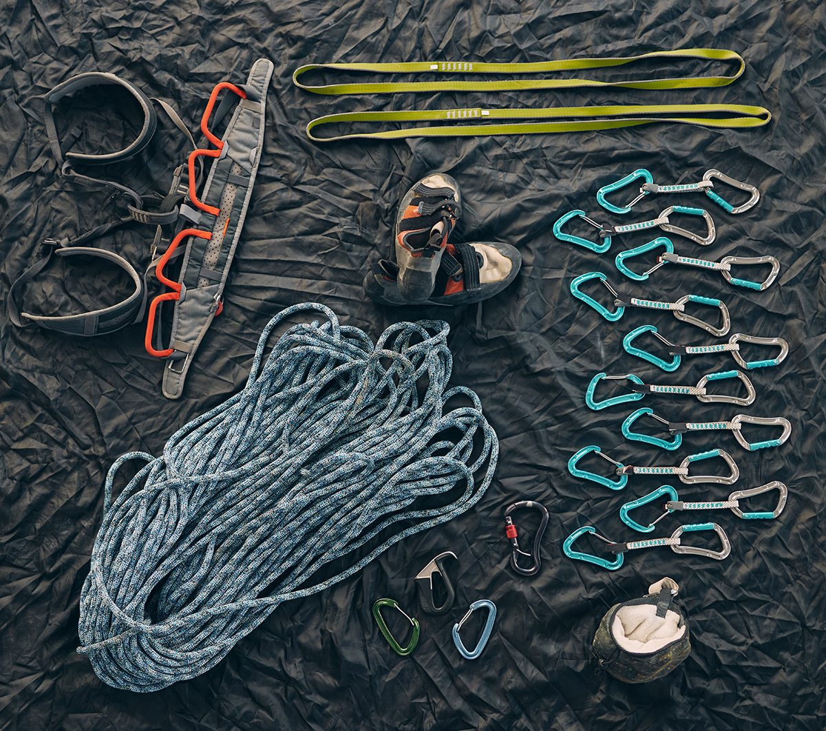 Closeup shot of a variety of carabiner hooks, rope, and other safety equipment used for rock or mou.