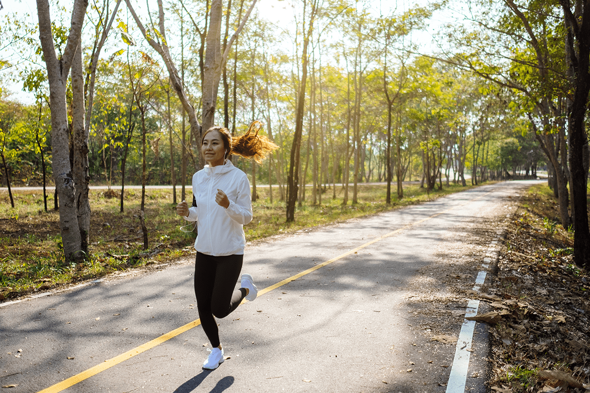 a-young-asian-woman-jogging-in-city-park-in-the-mo-2025-10-30-21-00-49-utc